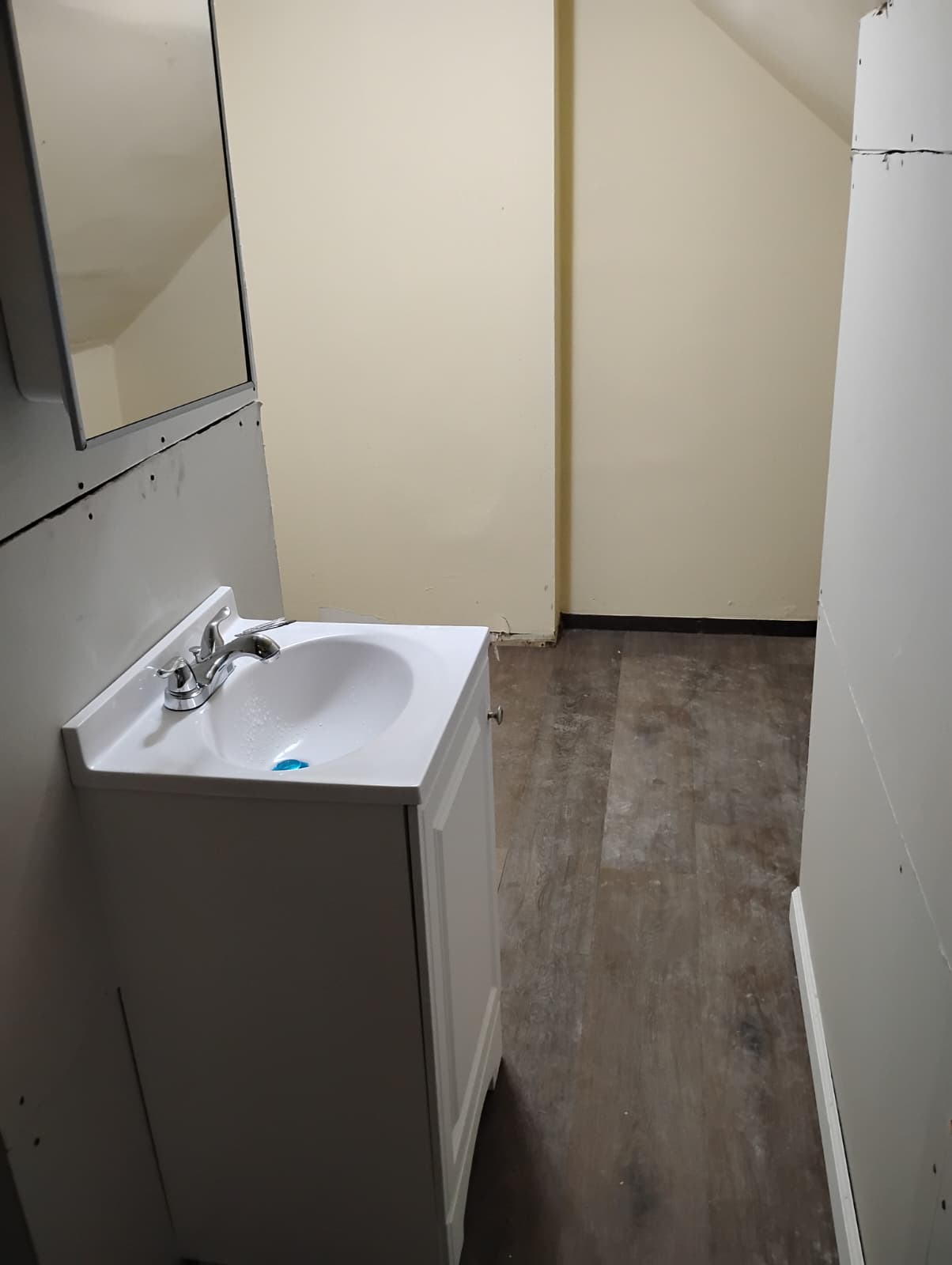 New vanity and medicine cabinet set with fresh drywall behind