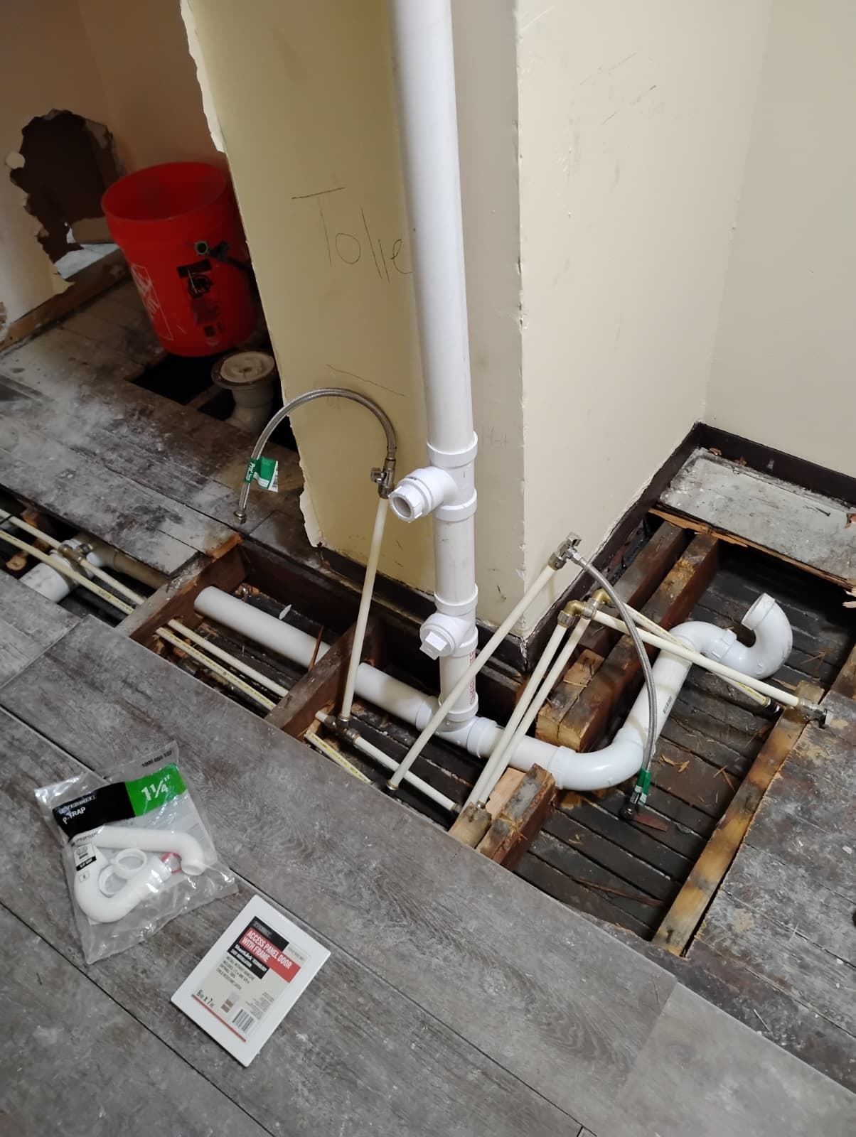 Drain, vent, and supply lines roughed in under the floor