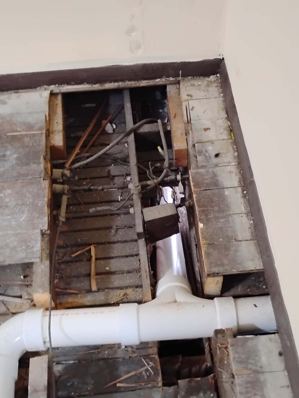 New PVC drain lines fitted between floor joists