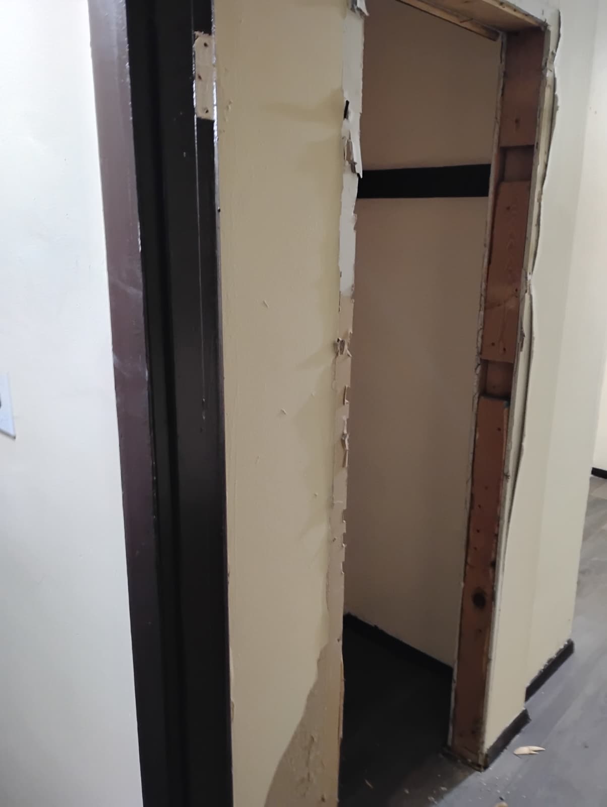 Sink wall opened up with old flooring exposed